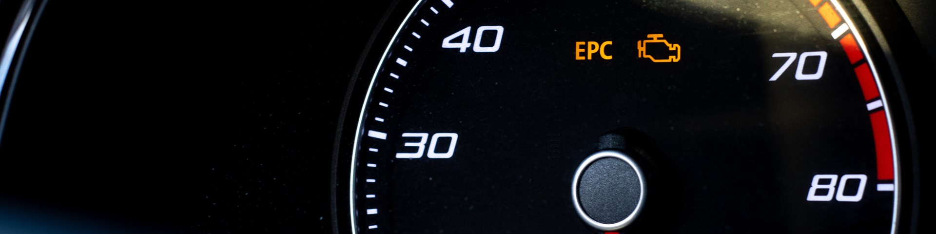 Clear image of vehicle dashboard showing warning lights