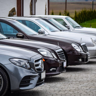 Luxury cars all parked in a row