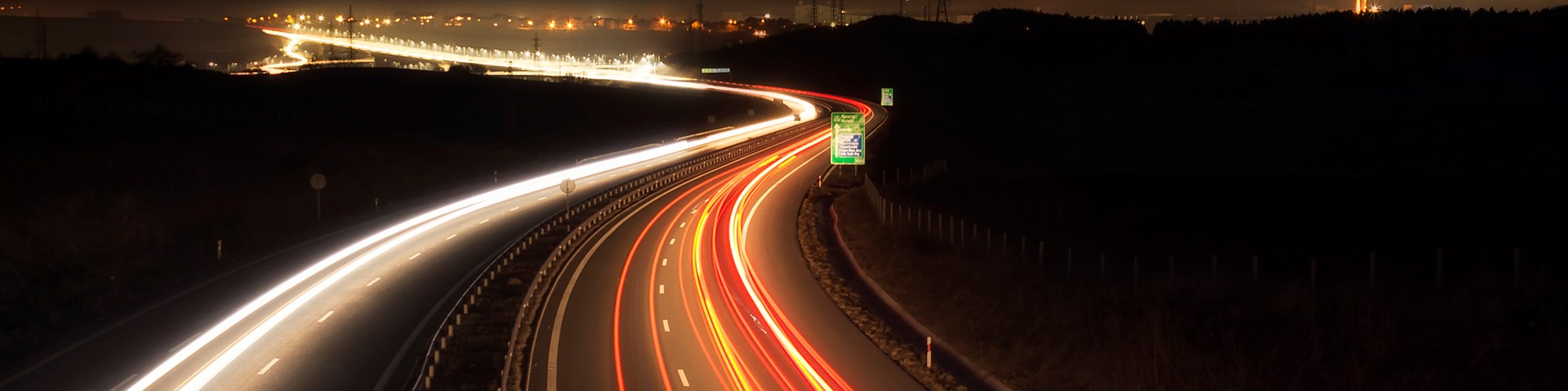 Nightime image of motorway showing bring vehicle lights